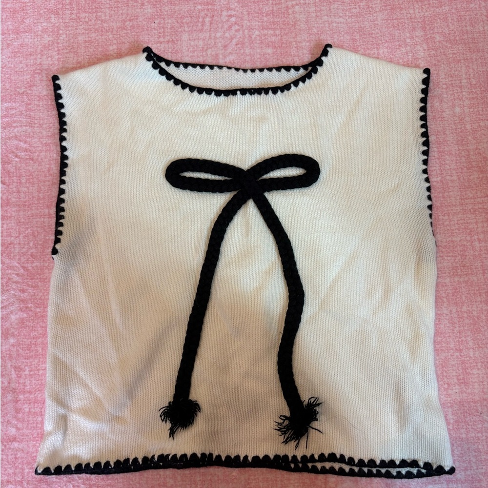 White Sleeveless Top with Black Bow Accent